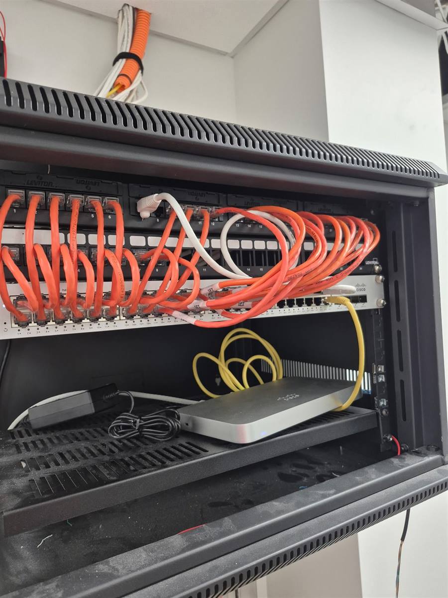 Small business network — wall-mounted rack with Leviton patch panels and Cisco switch